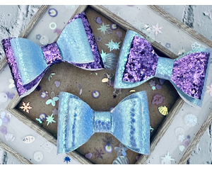 3 different lavender and purple bows. (Bows look blue in photos but are really lavender holographic.) Bows are sold individually.