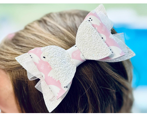 Layered white glitter bow with pink & white ghost design, with very light pink lace ribbon. Bow is approx. 5 x 2 1/2. Bow sold individually.