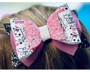 My 4 year old modeling a black glitter bow, with pink tulle, white with pink and black cute ghost print, w/ pink glitter and sequin on top.