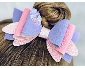 My 4 year old modeling a Lavender & pink glitter 4 layer bow. Top left corner of bow has iridescent pink embellishments.