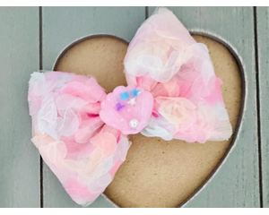 Textured floral inspired Soft pink, peach, blue, & yellow, hair bow, with Pink sparkle shell charm on top. Bow is approx. 4 x 3. 