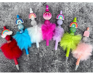 7 beaded rainbow inspired faux fur pens. Left to right: Red, blue, white, hot pink, lilac, green, and peach. Pens sold individually. 