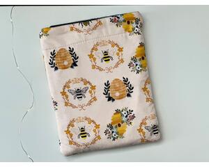 this beehive tablet sleeve has a light pink background with beehives and bees all over the insect tablet case