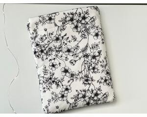 this floral tablet sleeve has a white background with black flowers and vines