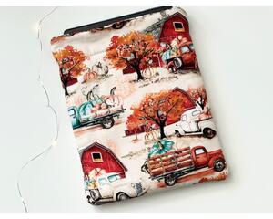 this fall tablet sleeve has a light brown background with barns, trucks filled with pumpkins and fall trees all over the autumn tablet holder