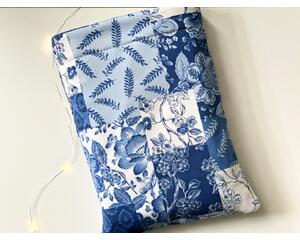 this quilted book sleeve has different shades of blues and white blocks. each block has a different print