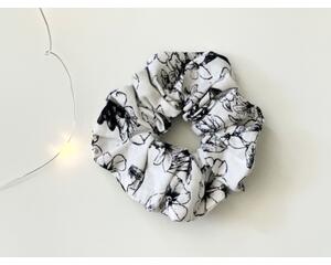 this floral scrunchie has a white background with black flowers