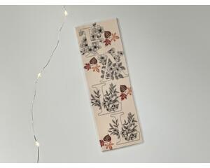 this fall bookmark has a beige background with the word fall in large print with flowers coming out of it and leaves in brown, red and yellow all over it