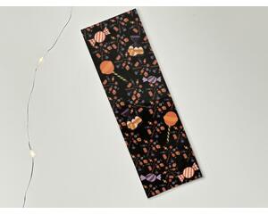 this Halloween candy bookmark has a black background with large candies surrounded by smaller candies