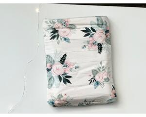 this floral book sleeve has a white wooden background with light pink flowers and light and dark green leaves