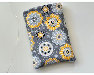 this floral book sleeve has a gray background with light gray, yellow, white and black flowers all over the book pocket