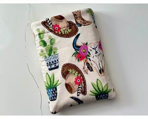 this western book sleeve has a light brown background with cowboy hats, boots, cacti & bulls all over the book protector