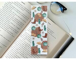 this western bookmark has a light brown with brown circles in the background. 
