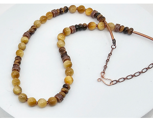 necklace features golden and brown banded tiger eye beads with copper accent rondelle beads, copper tubing and copper chain with hook clasp