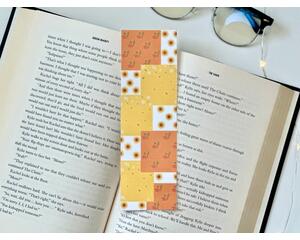 this fall patchwork bookmark has blocks of yellow, orange white blocks. Each block has a different pattern. Either fall leaves or fall flowers