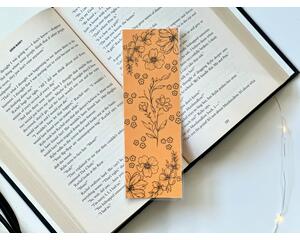this yellow floral bookmark has a mustard yellow background with black outlines of flowers all over the bookmark