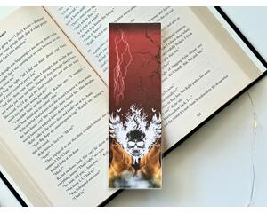 this skull bookmark has a ombre red background with lightning coming the sky and there is a crack on the right side. on the bottom there is a skull with wings coming out from a smoking flame