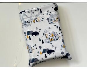 this book sleeve has a light gray background with mountains, bulls, trees, words like 'adventure, explore, roam wild.' all over the book holder