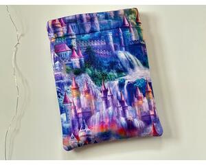 this castle book sleeve is purple with castles and waterfall all over the book holder.