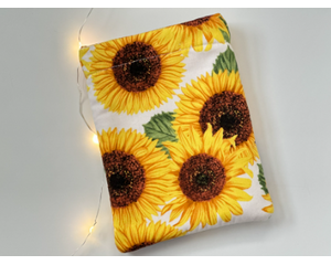 this sunflower kindle sleeve has a white background with large yellow flowers all over it