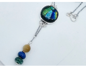 Dichroic glass: metallic blue, green, yellow hues. Lapis, malachite, and gold tiger eye beads dangle on chain from bottom. Silver chain
