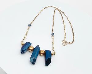 necklace features 3 blue quartz pendant stones and blue crystals with round gold spacer beads on gold-plated chain with a gold hook clasp