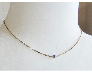 necklace - one small blue round crystal bead on a gold chain