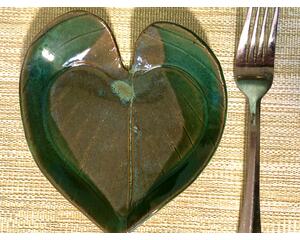 6x6" heart shaped plate with Hosta plant texture. Glazed with a dark green rim and a mixture of blue and grey throughout the middle. 