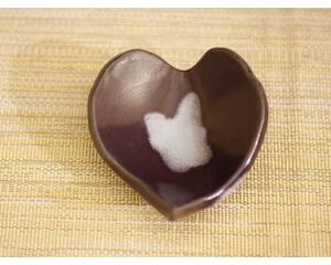 Ceramic heart shaped spoon rest. Glazed in dark purple and cream color. Approximately 3"x3.5"