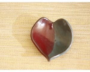 Ceramic heart shaped spoon rest. Glazed in red and blue. Approximately 3"x3.5"