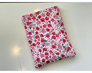 this floral book sleeve has a white background with tiny red and pink flowers and hearts all over it