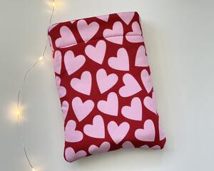 This heart book sleeve has a red background with pink hearts all over it.