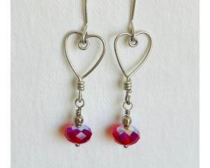 Silver wire shaped into hearts adorned with red crystal Swarovski beads. Great for Valentine's Day or any day.