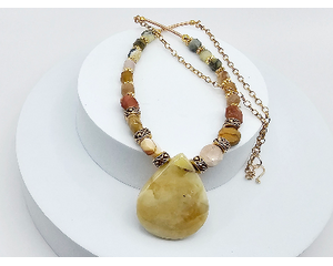 Handcrafted necklace with a yellow opal teardrop pendant, mookaite beads, brass accents, and a gold-toned stainless steel chain