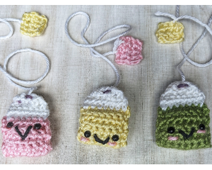 "Close-up of a cute, handmade crochet bookmark in teabag shape"
