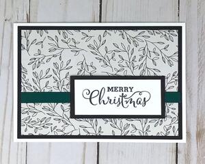 Merry Christmas card making kit with botanical scrapbook paper, black cardstock mat, stamped "Merry Christmas" sentiment and green ribbons.