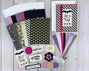 A Halloween card kit with cardstock, scrapbook paper, embellishments and cards and envelopes to make 6 assorted pastel cards.