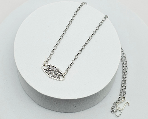 Handcrafted 18-inch silver-toned necklace with a delicate filigree pendant, perfect for layering and spring fashion.