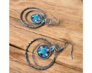 A trendy long pair of western earrings are handmade and flashy. hoop earrings with concho.
