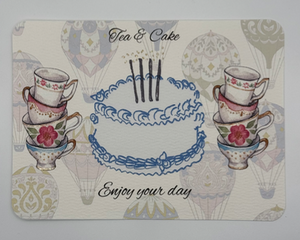 Watercolor design, hot air balloon background featuring cake with gold foil accented candles surrounded by teacups