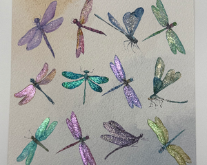 Watercolor dragonfly collage wall art adorned with shimmery iridescent paint to add depth and detail to the wings