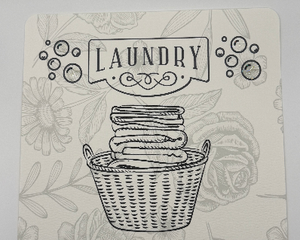 AHumorous Laundry Room Art featuring laundry basket with phrase “one small load a day keeps the heaps of laundry away”