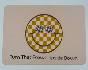 Modern smiley face with checker design wearing sunglasses accented in shiny paint, phrase turn that frown upside down 