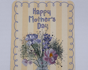 Yellow striped card with blue squiggle design border featuring clear vase of wildflowers with the text ‘Happy Mother’s Day’