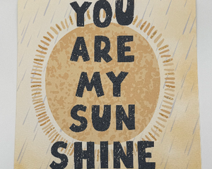 8x8 children’s books all art featuring watercolor sun and the text you are my sunshine accented in gold glitter