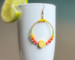 Fun, bright and fresh fruit earrings, with lemon as the focal point and seed beads in yellow, orange, pink and green. Gold plated hook wire.