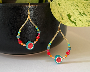 Fun, bright and fresh watermelon earrings, with seed beads in orange, red, green and teal. Gold plated French hook. 1 3/4" long by 1" wide.