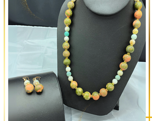 Agate stone with multiple colors. Gold spacers are used between each bead. The necklace is 20 inches long. Included are matching earrings.