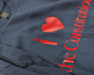 Front of the navy tee-shirt says "I heart the constitution."  in red letters and displays the red heart on the right sleeve.