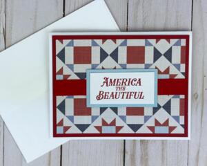 A 4th of July card making kit with cardstock, quilt scrapbook paper, stamped sentiments and mats, ribbons and cards and envelopes.